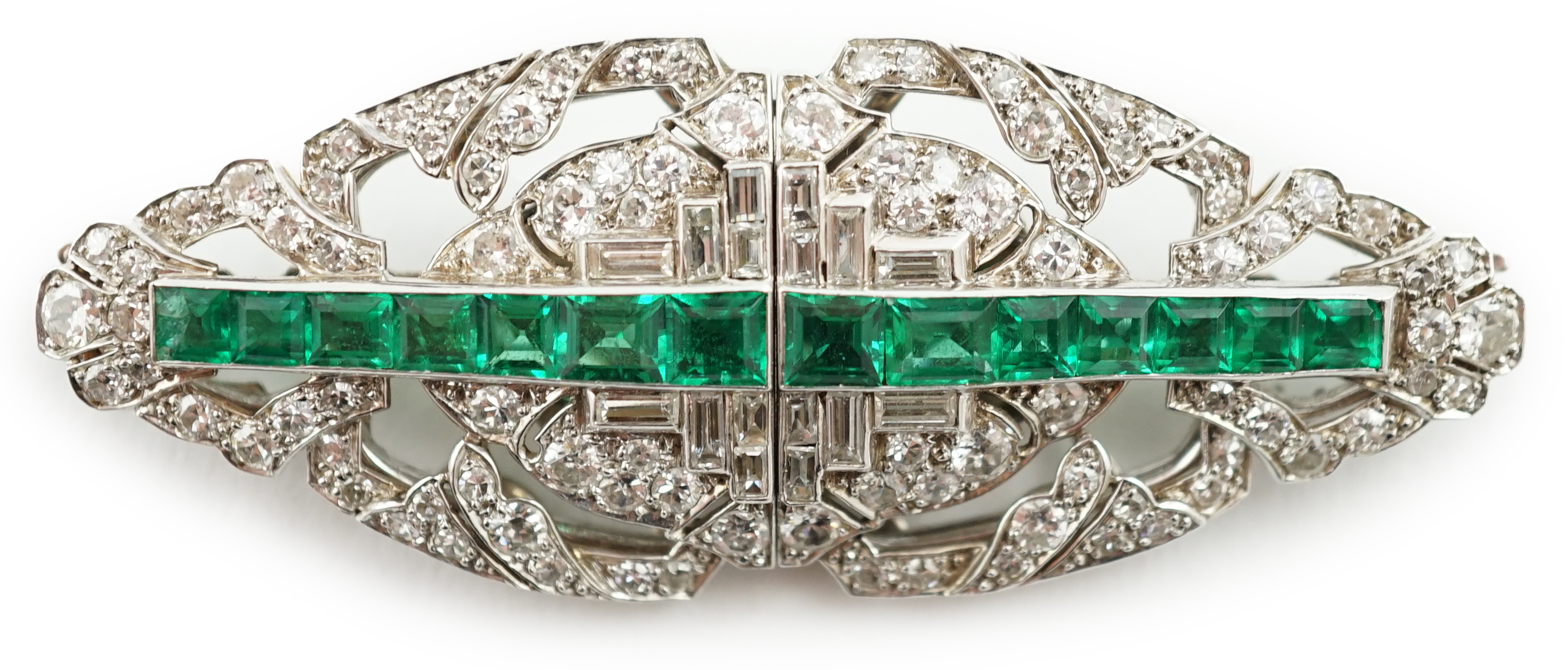 A 1930's/1940's white gold, emerald and diamond double clip brooch